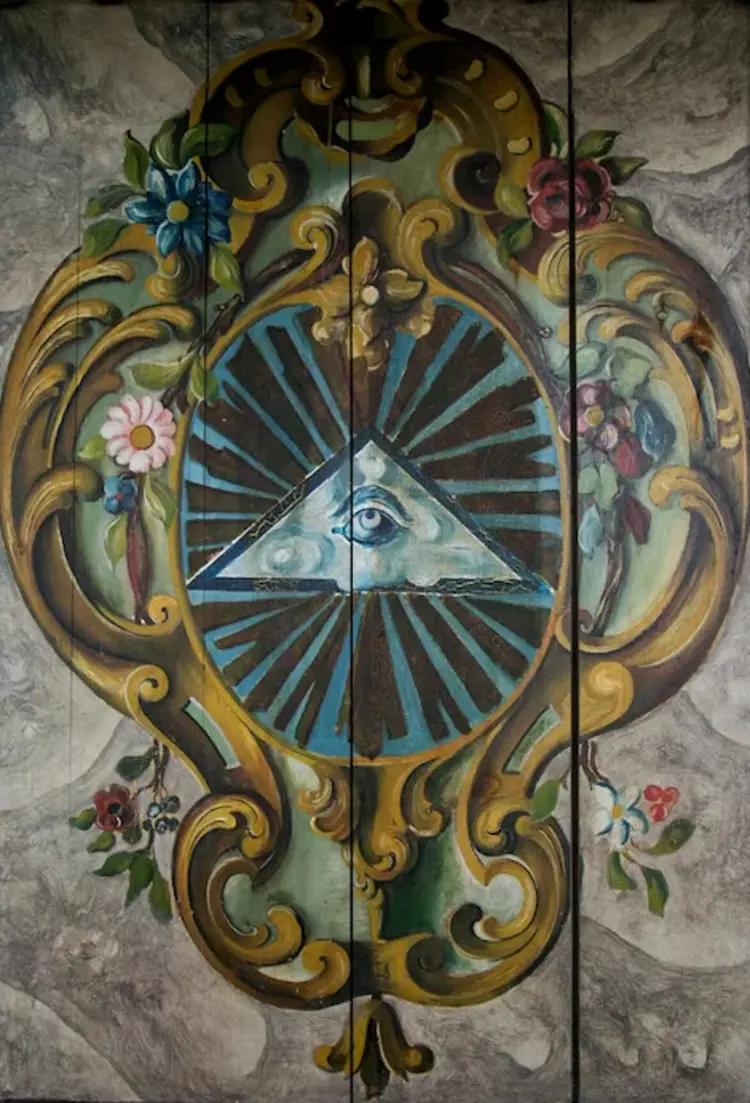 Tafelbild - ein Auge Gottes mit Lichtstraheln und Blumenkranz auf Holz gemalt.